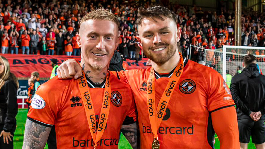 Glenn celebrates lifting the Scottish Chamionship with teammate Craig Sibbald 