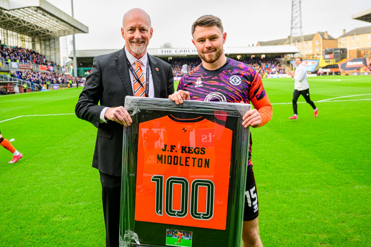 Glenn Middleton presented with his 100 matches framed shirt by Chairman Mark Ogren